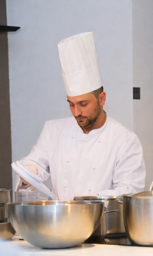 Chef Mario Gaeta in the kitchen of Osteria Le Castelline, applying Michelin-starred techniques to create contemporary Tuscan cuisine.